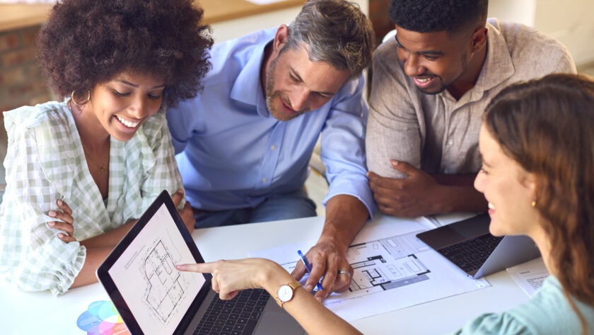 Male And Female Architects With Laptop Meeting And Discussing Building Plans In Modern Office